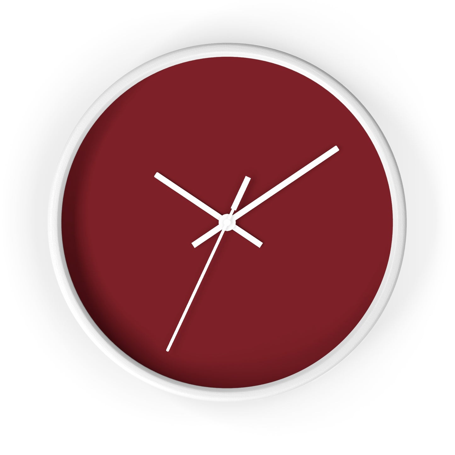 White circular wooden framed clock with dark red background and white hands against a white background.
