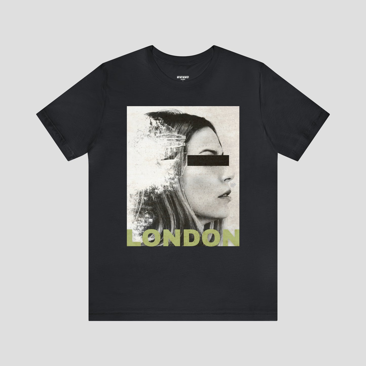 Black t-shirt with large, black and white, distressed image of a woman's facial profile. A black bar is over her eyes and the word London is on bottom of image in capitalized light yellow block letters. The shirt image is against a gray background.