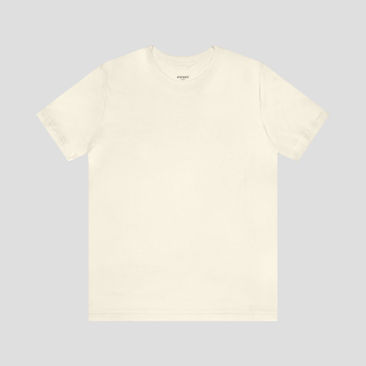 Solid cream colored t-shirt with no image or text, against a gray background.