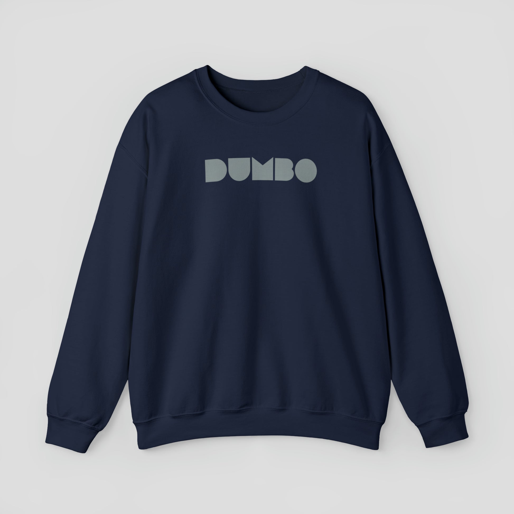 Navy colored sweatshirt with the word Dumbo in gray block letters across the chest, against a gray background.