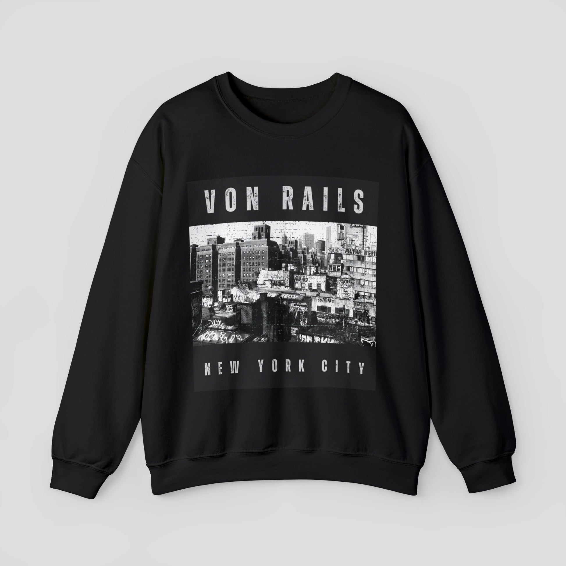 Front view of black sweatshirt with a black and white distressed image of New York buildings with the words Von Rails at the top and New York City at the bottom in distressed white lettering, against a gray background.