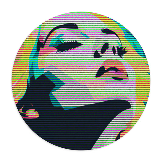 Round mousepad with colorful pop art illustration of blonde woman's face with her eyes clothes and looking up, against a white background.