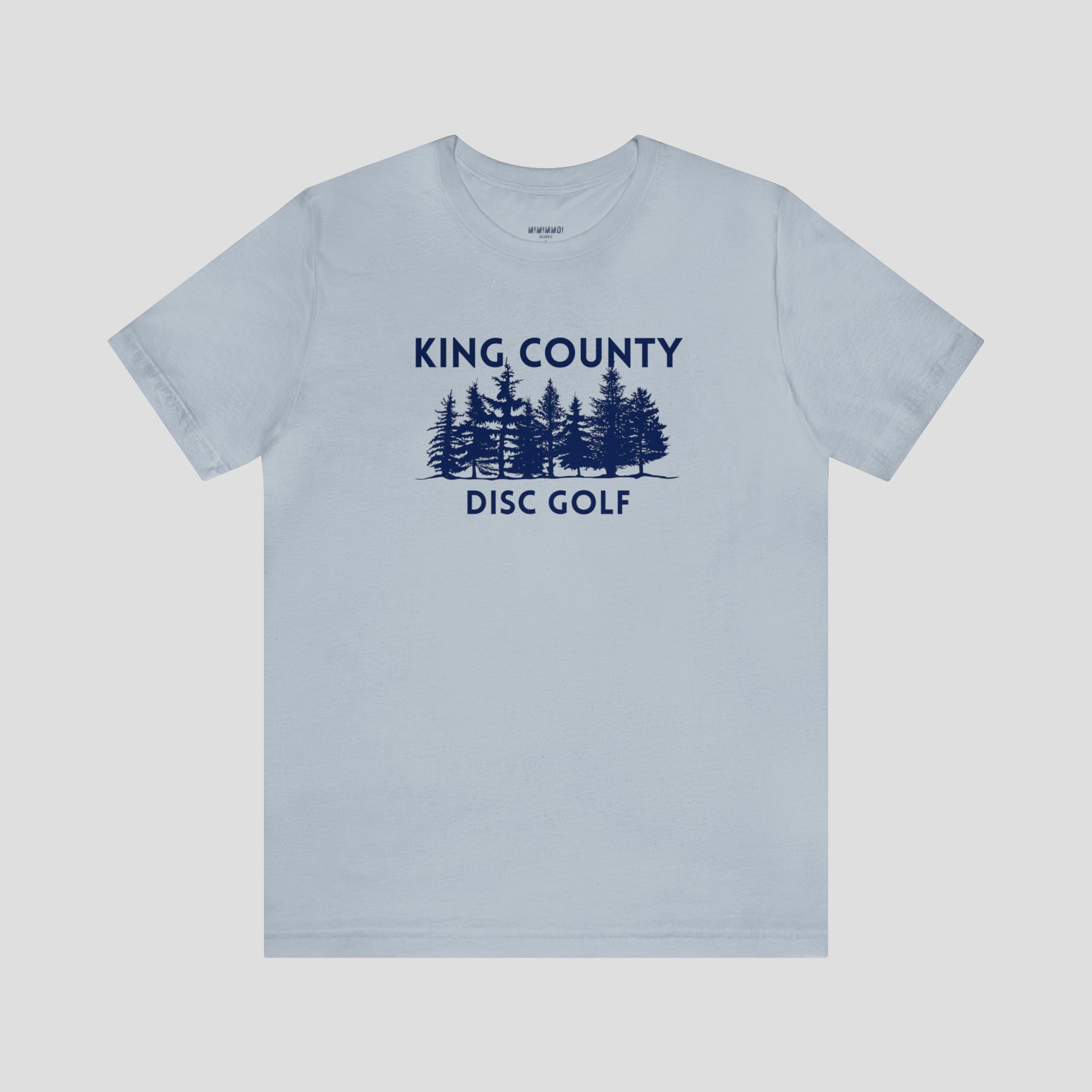 Light blue t-shirt with navy letters and trees against a white background.