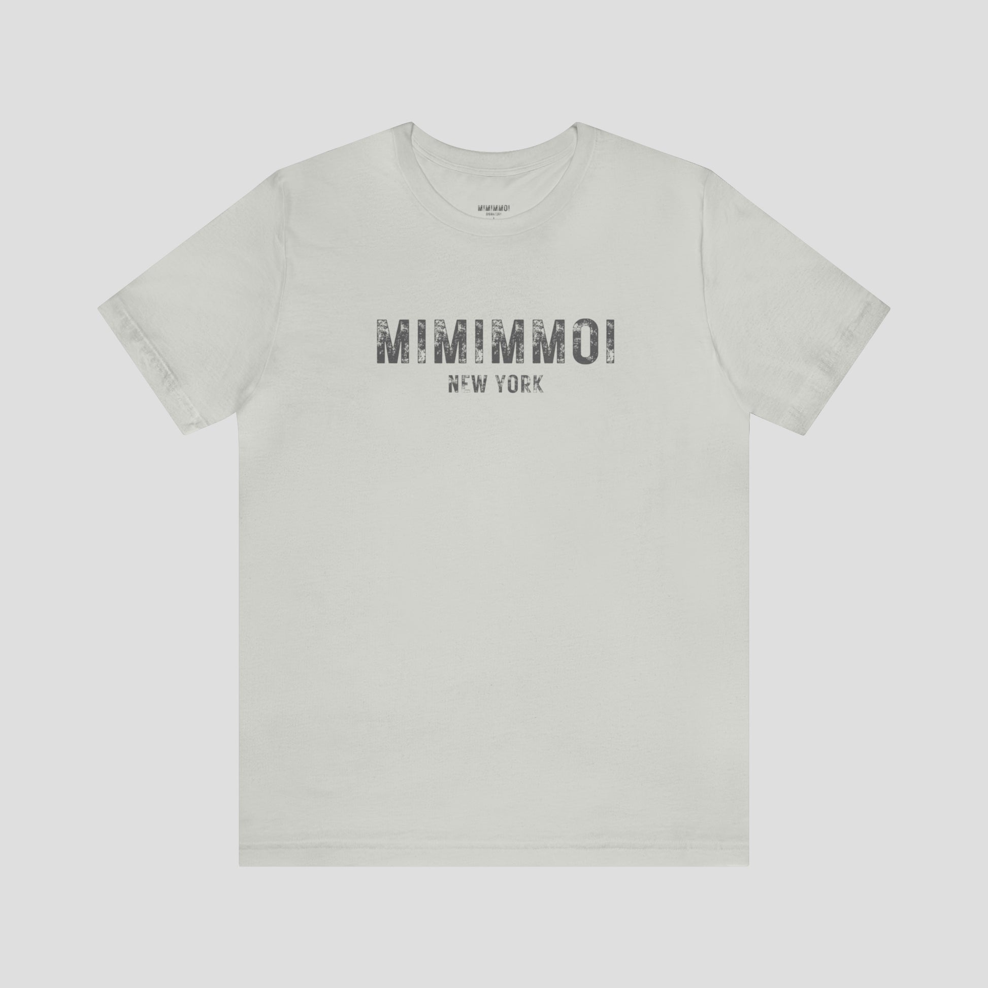 Silver-gray t-shirt with the words Mimimmoi New York in distressed gray block letters across the chest, against a gray background.