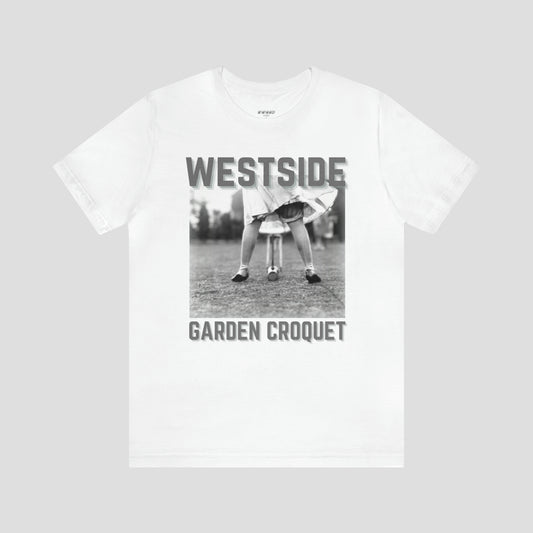 White t-shirt with gray letters and a vintage photo of person bent over playing croquet against a light gray background.