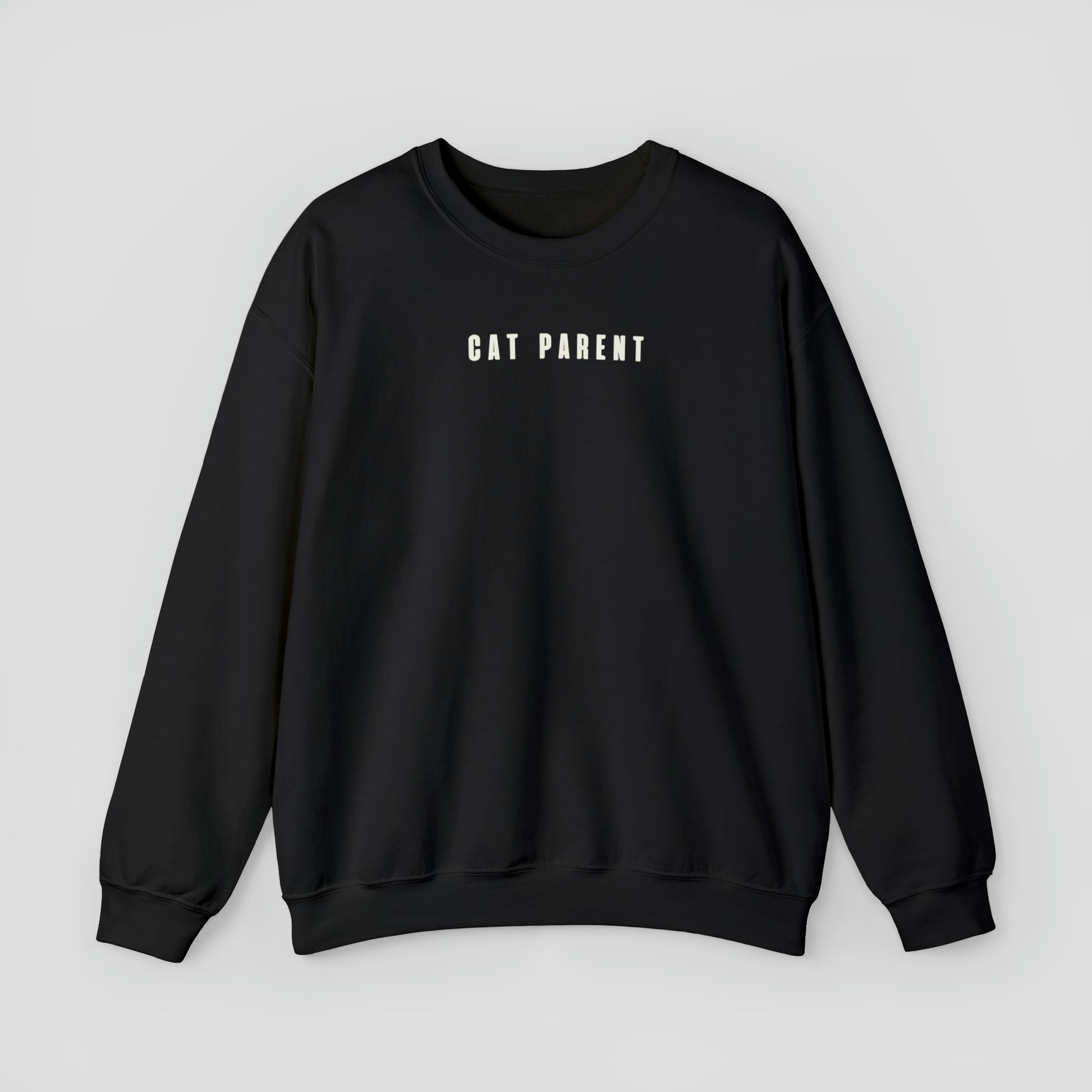 Black sweatshirt with "Cat Parent" in small white letters against a light gray background.