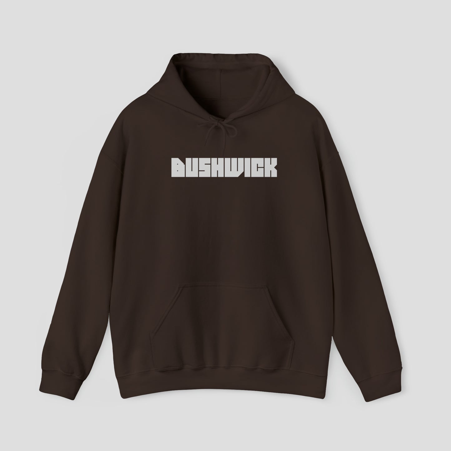 Front view of a brown hooded sweatshirt with hood down and the word "Bushwick" in a large white block letters in center, against a gray background.